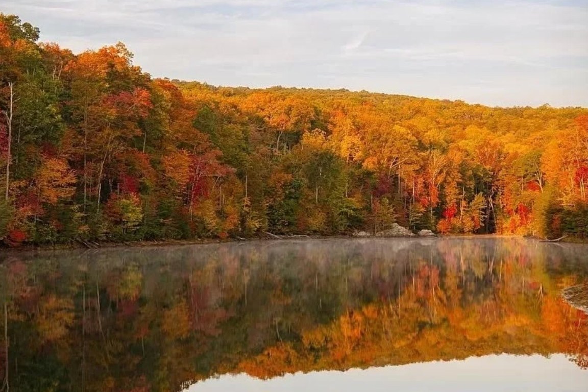 Autumn forest reflected in the 7-acre private lake at Tiba Tennessee